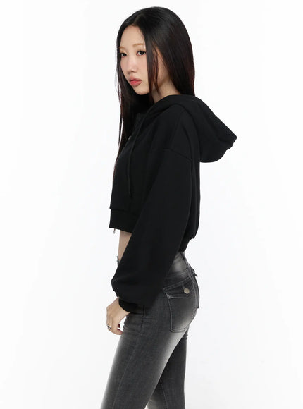 Zip-Up Crop Hoodie CL527 Black side shot on model showing hood and ribbed cuff detail styled with gray skinny jeans