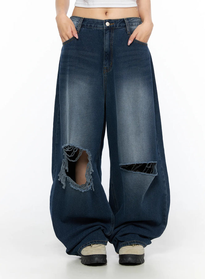 Zovie Distressed Washed Wide Leg Jeans CL514 Dark blue front close-up on model showing large knee rip distressing and faded wash denim texture