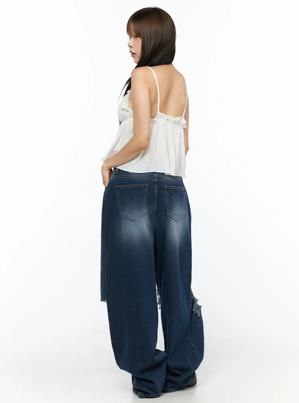 Zovie Distressed Washed Wide Leg Jeans CL514 Dark blue back three-quarter shot on model with white cami revealing back pockets and ripped knee detail