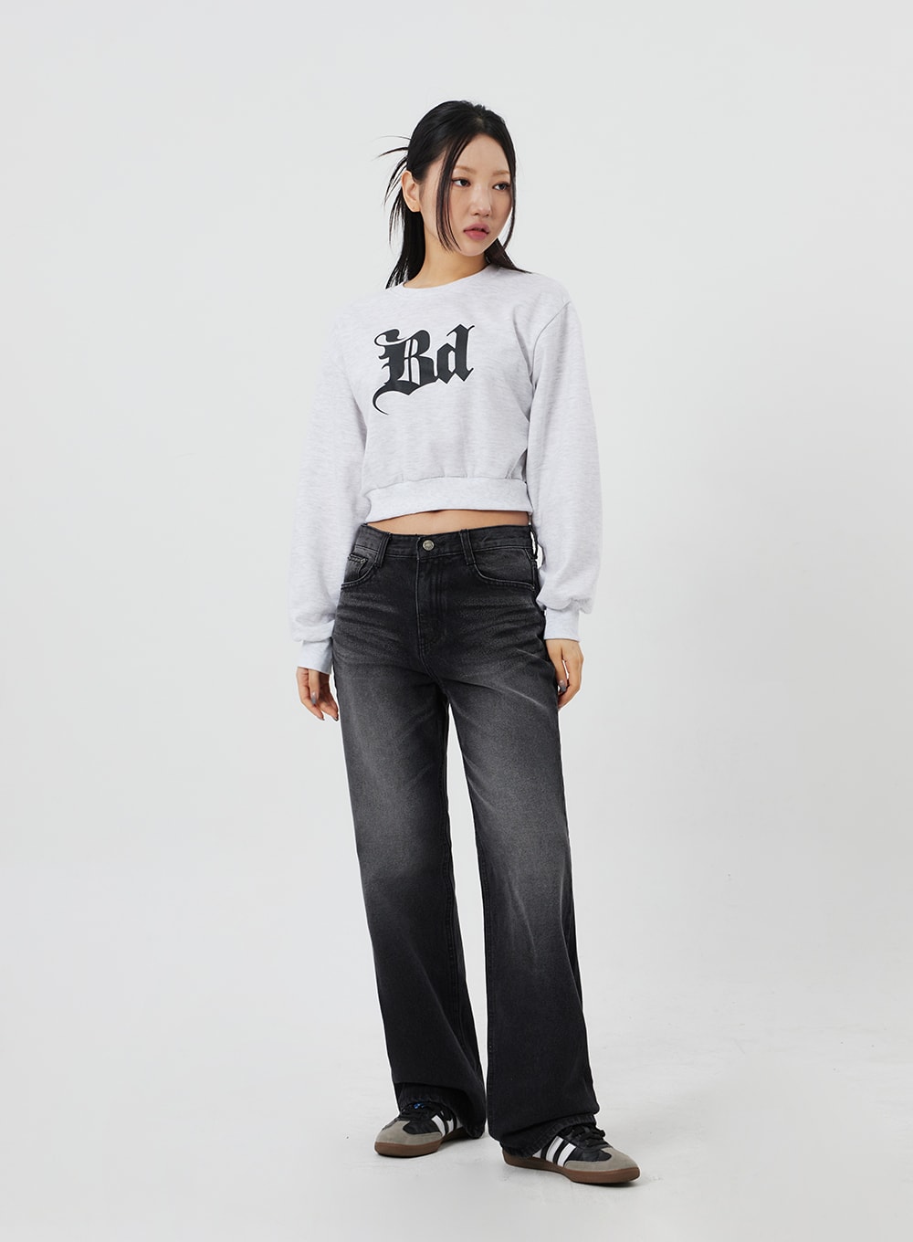 LEWKIN Mid-Rise Bootcut Jeans CF327 in black, full-body front on model, faded washed denim with wide bootcut leg, paired with grey crop sweatshirt and sneakers.