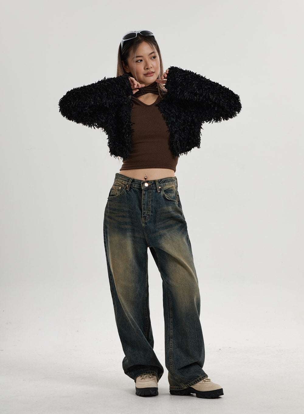LEWKIN Vintage Washing Wide Leg Denim Pants CN14 in vintage washed indigo, full-body front on model, wide-fit cotton denim with yellow-brown fading, paired with black shaggy cardigan and brown crop top.