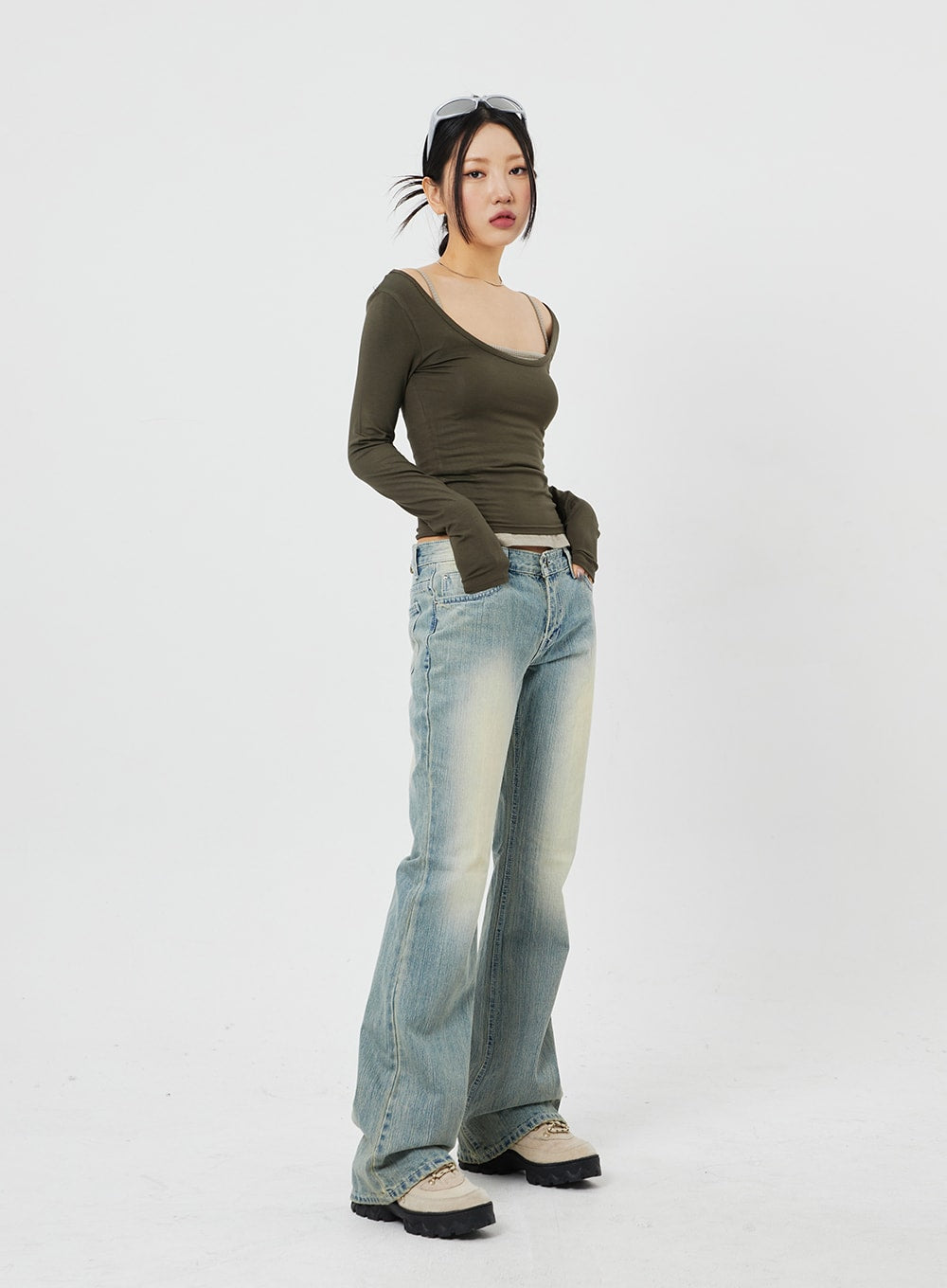 LEWKIN Low Rise Bootcut Jeans CF315 in light blue, angled full-length shot on model, vintage wash slim bootcut denim, paired with olive crop top and chunky boots.