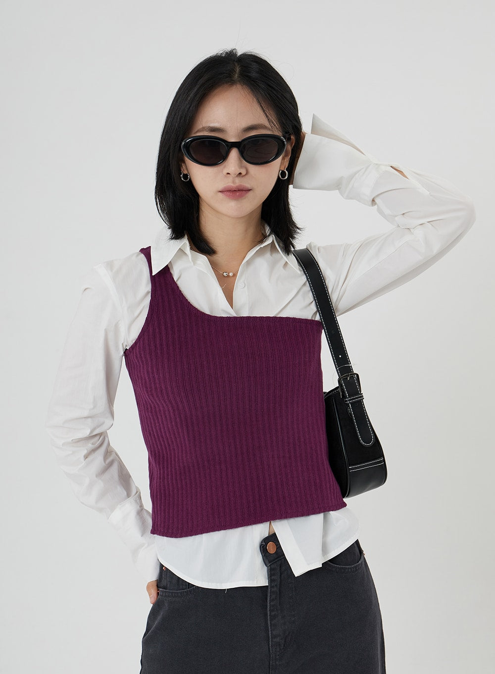 Maxi Denim Pants ON23 in charcoal grey, upper half and waistband shot on model wearing sunglasses and black shoulder bag, wide-fit denim top detail, layered with white shirt and purple knit vest.