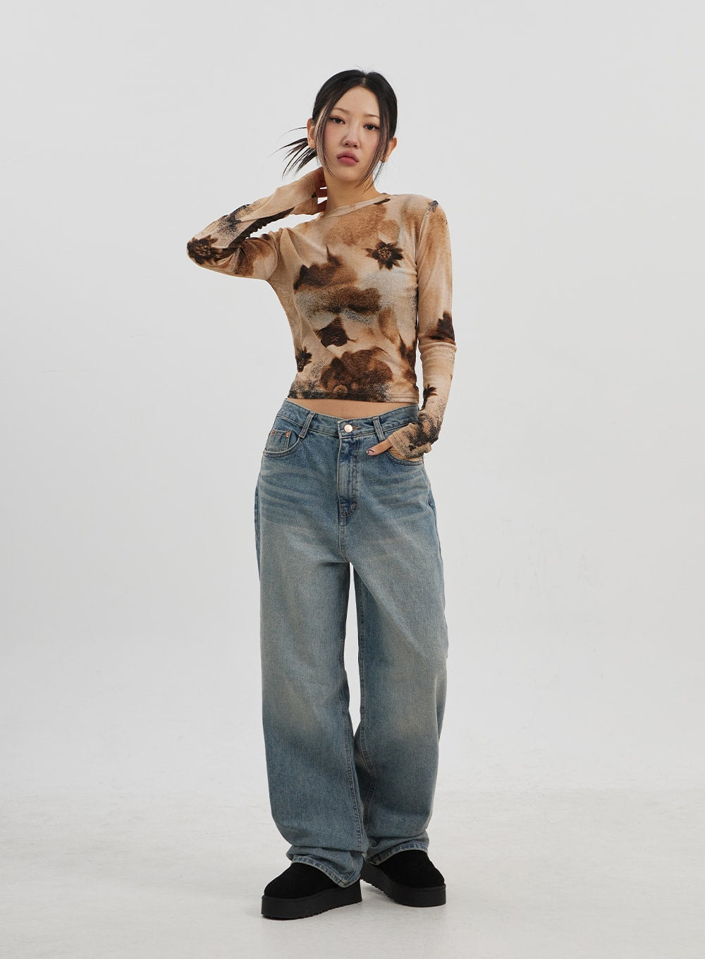 Low Rise Baggy Jeans CJ330 in Blue, full-body front shot on model, wide-leg silhouette with faded wash, styled with brown tie-dye long sleeve top and black platform slides.
