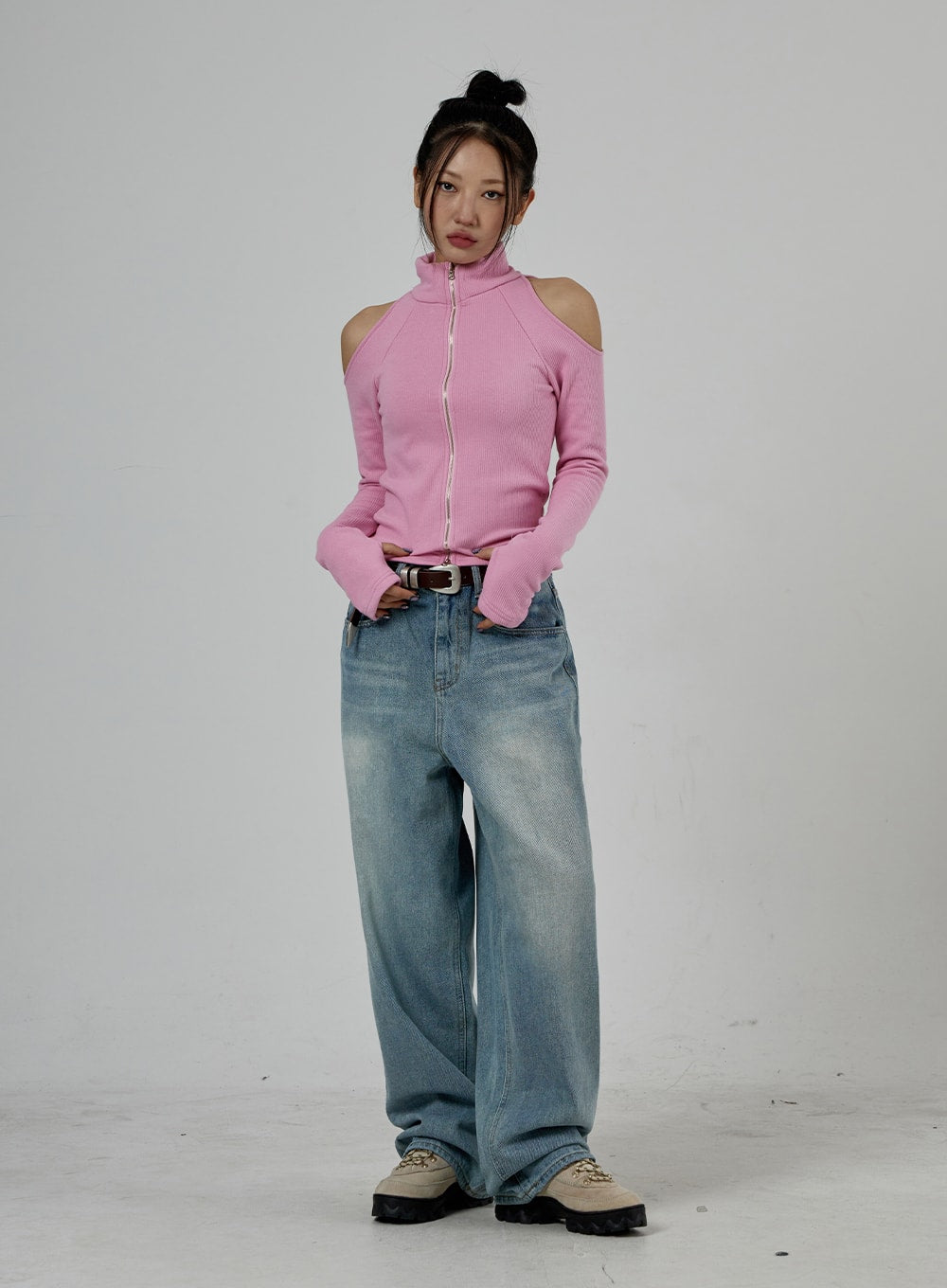 LEWKIN Light Wash Baggy Jeans Unisex CD26 in light blue, full-body front shot on model, wide-fit washed cotton denim pooling at hem, styled with pink cold-shoulder zip top and belt.