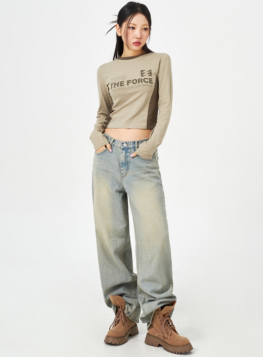 LEWKIN Light Blue Baggy Jeans CM323 in light blue, full-length front shot on model, wide-fit washed denim with vintage fade, paired with khaki crop top and brown boots.