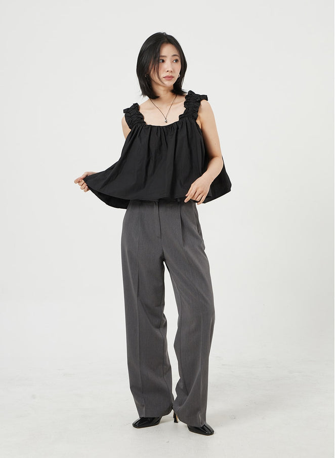 LEWKIN Basic Tailored Pants OM328 in dark gray, front full-body on model standing, wide-fit pintuck trousers with straight leg, paired with black ruffled camisole top and black heels.