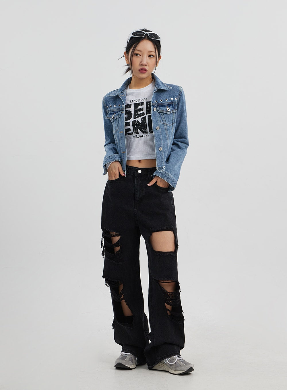 LEWKIN Ripped Wide Leg Jeans CJ319 in black, full-length front on model, heavy destroyed distressing throughout, wide cotton denim fit, styled with blue crop denim jacket and graphic tee.