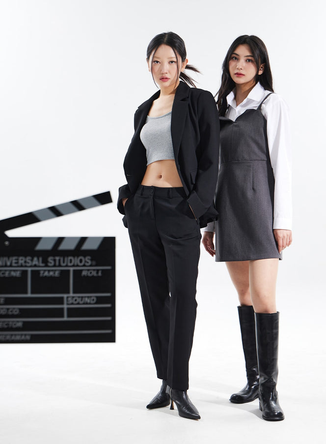 Basic Tailored Pants BM304 in black, full-length front shot on model with hands in pockets, straight-fit pintuck trousers paired with black blazer and heeled ankle boots, studio setting.