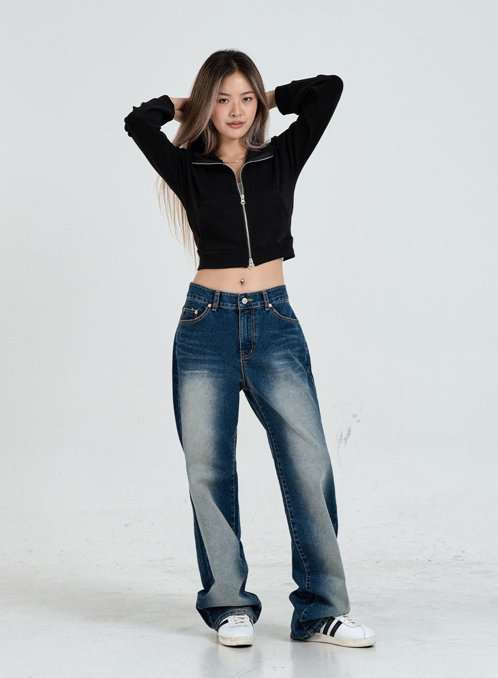 LEWKIN Wide Leg Faded Color Denim Pants CO11 in blue gradation, full-body front shot on model, hands behind head, wide cotton leg with faded wash, paired with black crop zip jacket and white sneakers.