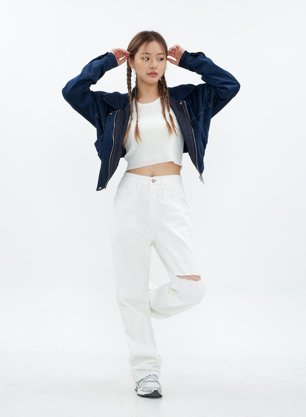 LEWKIN Torn Wide Leg Jeans CM18 in white, full-body front view on model with one leg raised, wide-fit cotton with knee cut-out, paired with ribbed crop top and navy jacket.