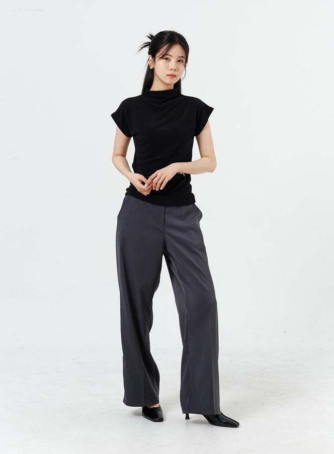 Wide Leg Tailored Pants OM320 in charcoal gray, front full-length on model with relaxed stance, wide-leg silhouette showing smooth drape, styled with black sleeveless top and black kitten heels.