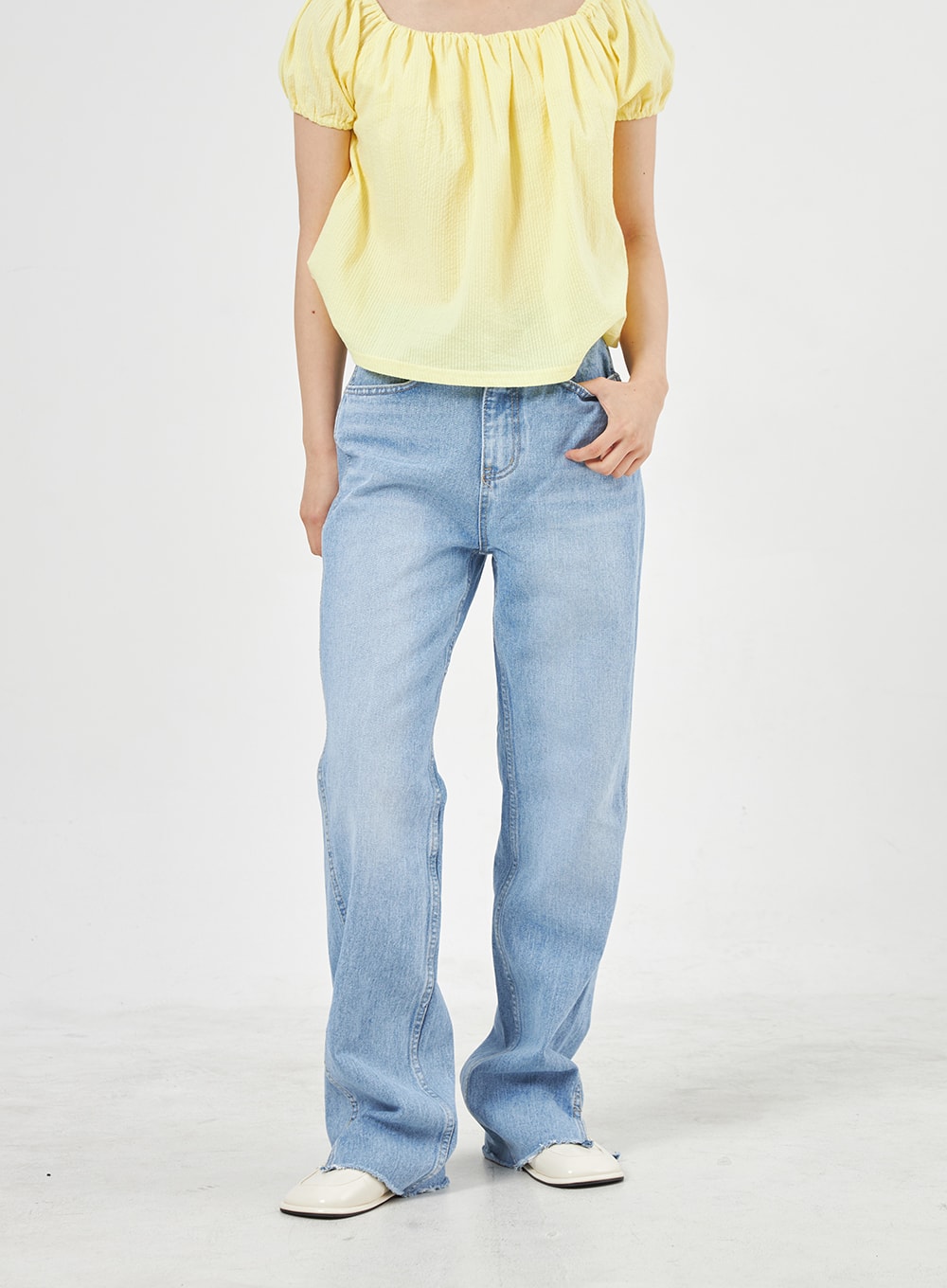 Light Wash Jeans OA310 in light blue, front full-length shot on model, wide-leg silhouette with high waist and side slit at hem, styled with yellow square-neck top.