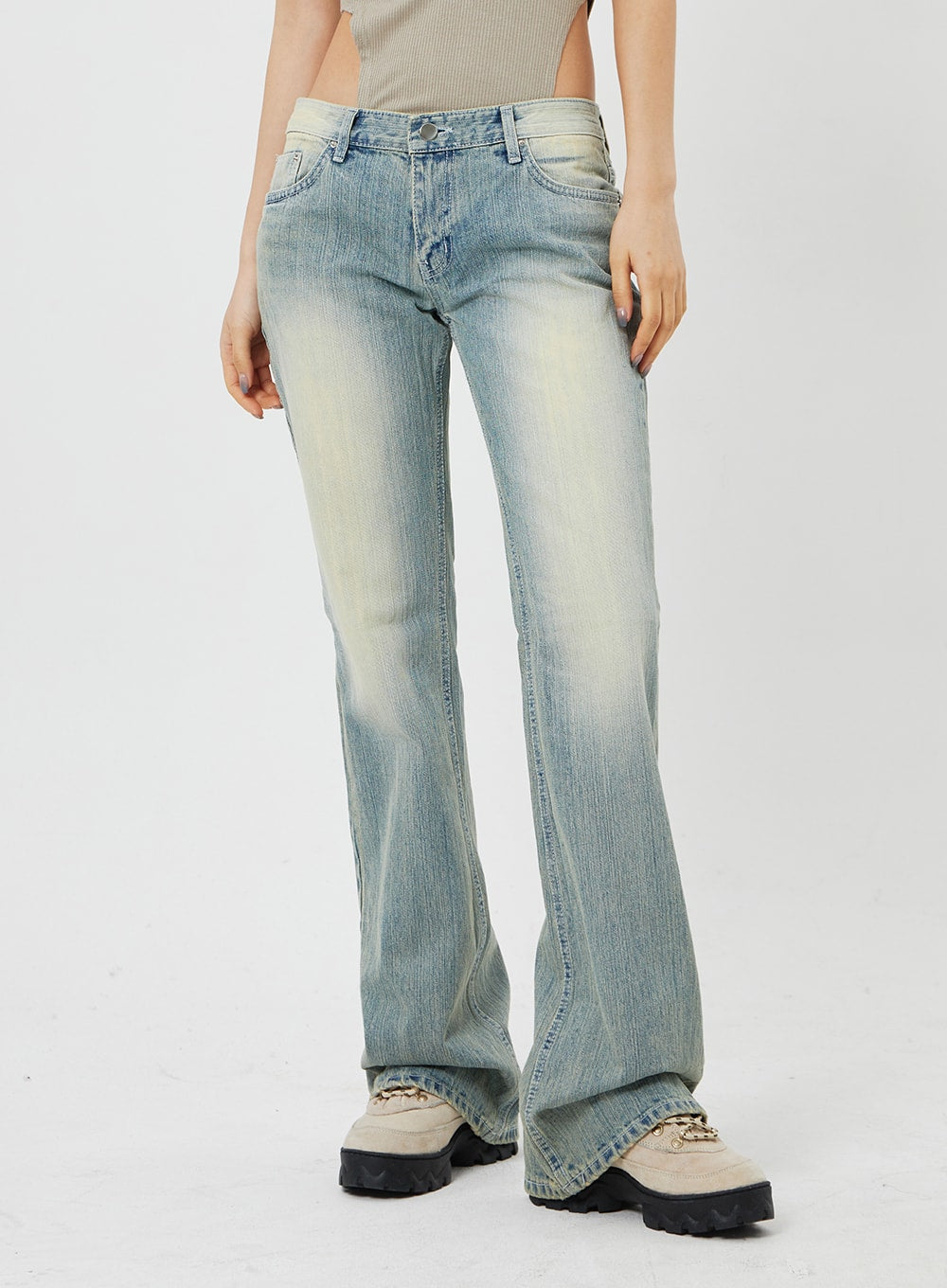 Low Rise Bootcut Jeans CF315 in light blue, front waist-to-hem close-up on model, low-rise waistband with button fly, faded wash and flared bootcut leg.