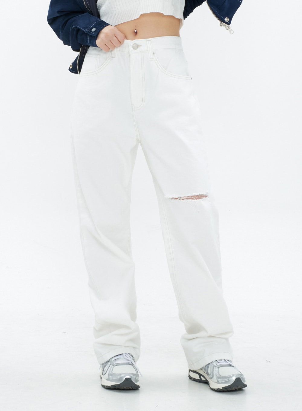 Torn Wide Leg Jeans CM18 in white, front close-up from waist to hem on model, showing knee cut-out detail, contrast stitching, and relaxed wide leg, styled with sneakers.