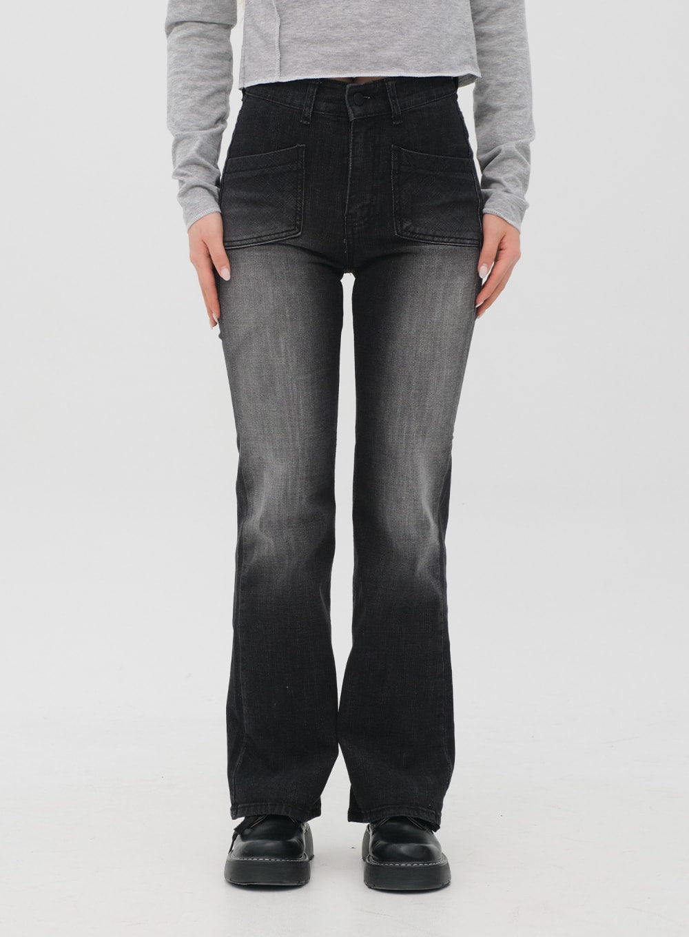 Bootcut Jeans M4 in black gradation wash, cropped front close-up on model, high-waist patch pockets visible, faded gradation denim, bootcut silhouette, normal fit.