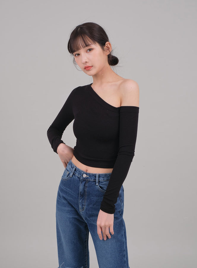 LEWKIN One Shoulder Crop Top C2701 in black, front close-up on model, asymmetric neckline baring one shoulder, tight rayon-spandex crop fit, paired with blue jeans.