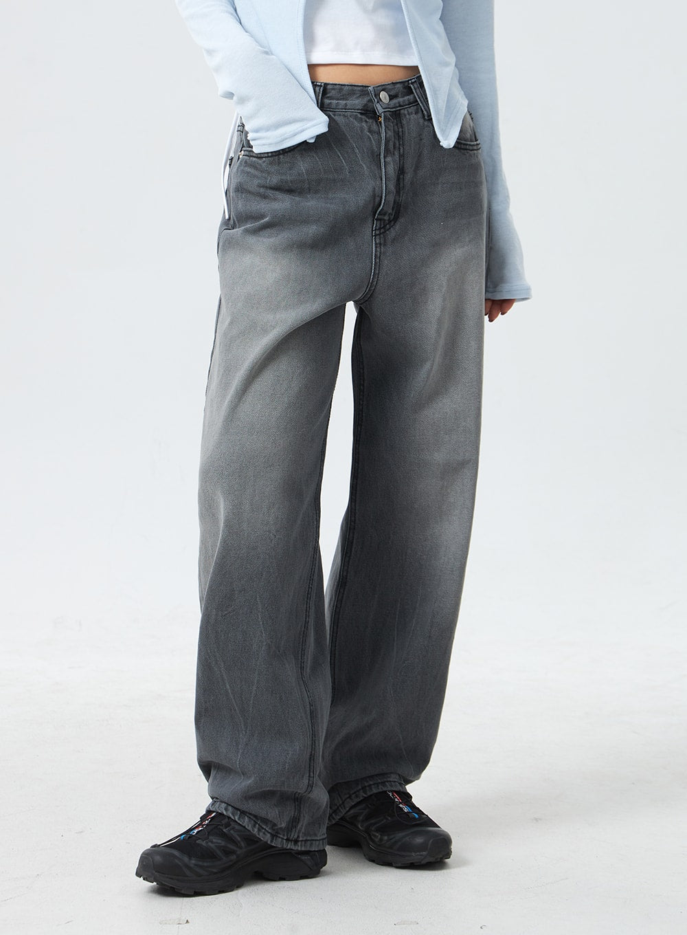 Low Rise Mid-Wash Jeans CM327 in grey, cropped front close-up on model from waist to hem, wide-leg silhouette with low waist, button fly, and subtle mid-wash fading on cotton denim.