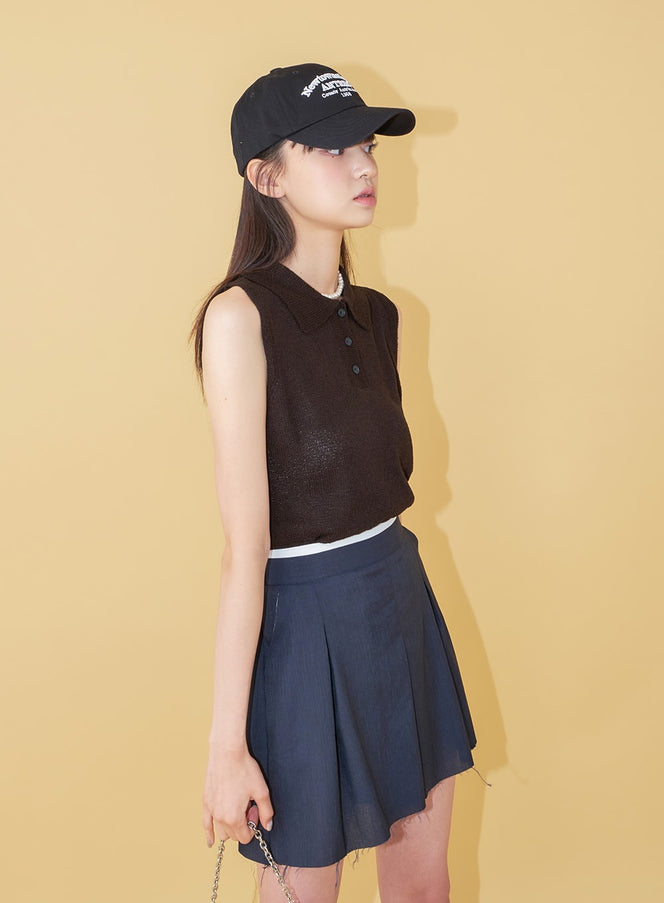 New Town Lettered Cotton Baseball Cap OU13 in black, side profile on model, structured cotton brim, styled with sheer dark knit vest and navy mini skirt, holding chain bag.