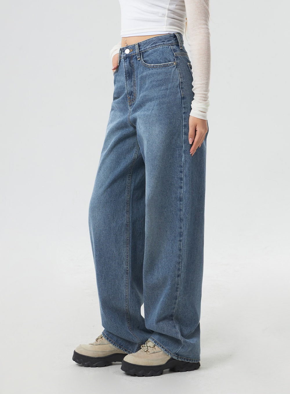 Wide Leg Mid-Wash Jeans CM331 in mid-wash blue, side view cropped at waist on model, wide-leg silhouette with faded wash, 5-pocket styling, high-rise fit visible.