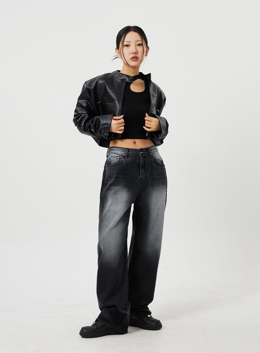 Mid-Rise Baggy Jeans CF328 in black, front full-length shot on model, wide-fit washed cotton denim paired with black faux-leather crop jacket and black crop top, standing pose.