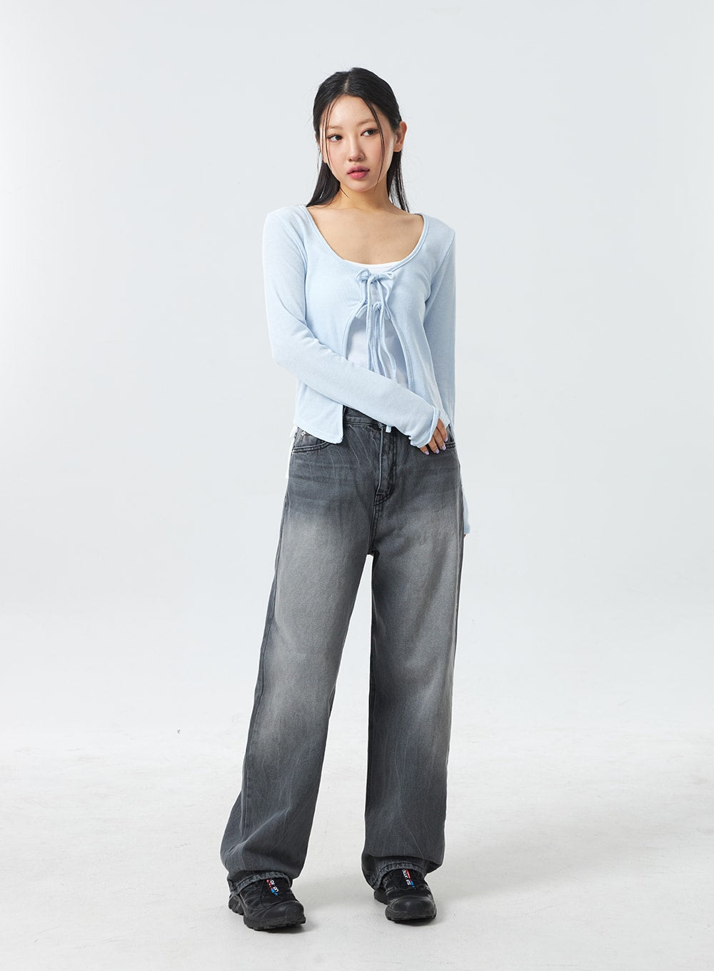 Low Rise Mid-Wash Jeans CM327 in grey, full-length front shot on model with slight body turn, wide-fit washed denim showing gradual fade, styled with sky blue tie-front top and chunky sneakers.