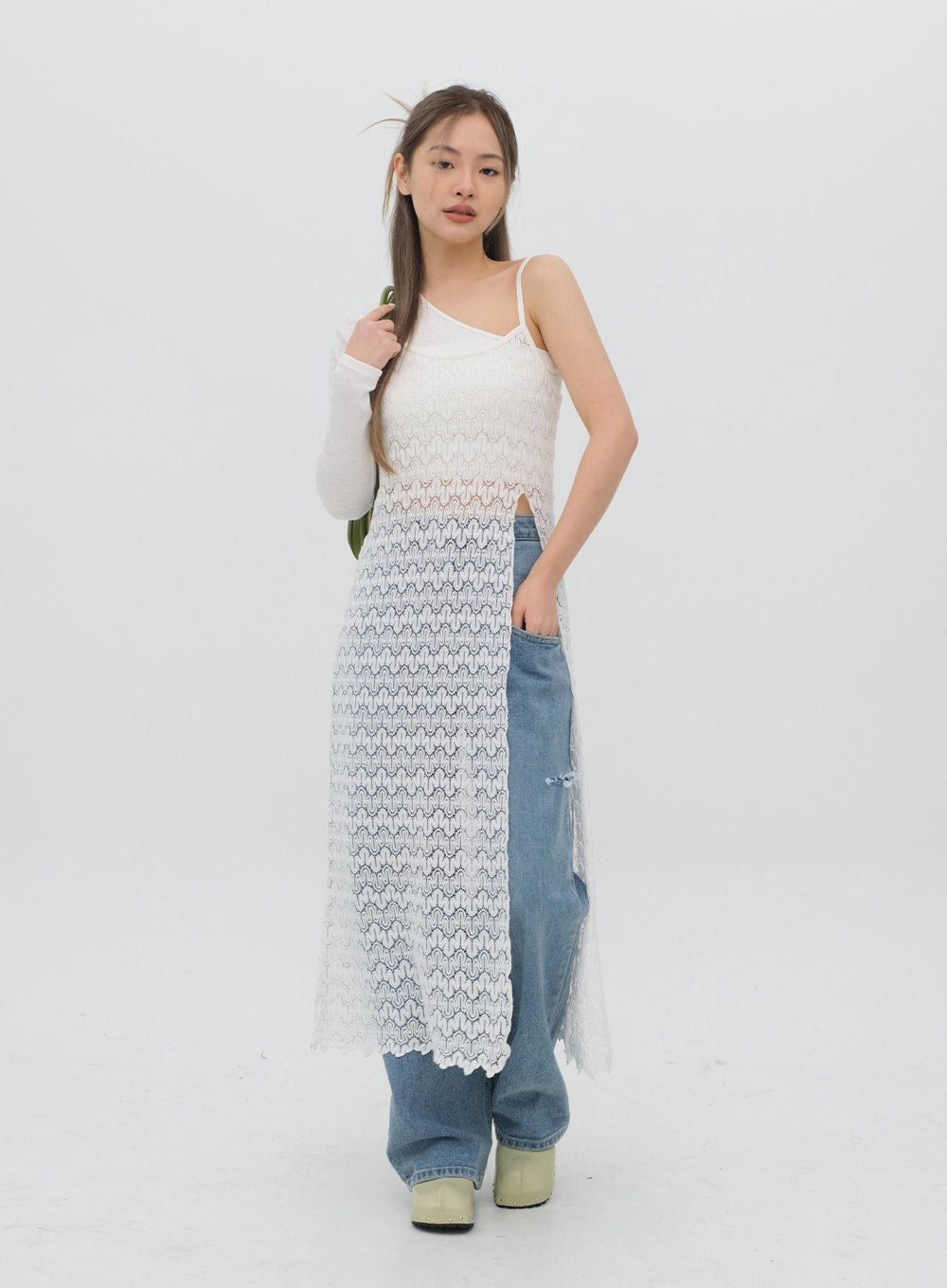 Torn Wide Leg Jeans C1002 in light blue, three-quarter front angle on model, wide-leg cotton denim visible beside sheer lace overlay, ripped knee showing, green clogs.