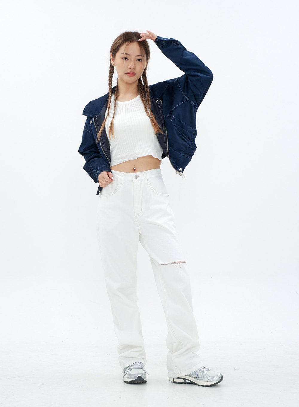 Torn Wide Leg Jeans CM18 in white, full-body front view on model standing naturally, wide-fit long cotton jeans with knee cut-out, paired with white crop top and navy jacket.