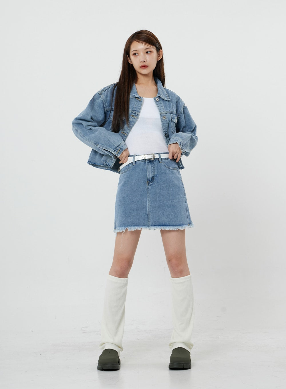 Sienna Crop Jeans Jacket CS21 in light blue, full-length front view on model, oversized crop silhouette worn open over white tank and denim mini skirt with white knee boots.