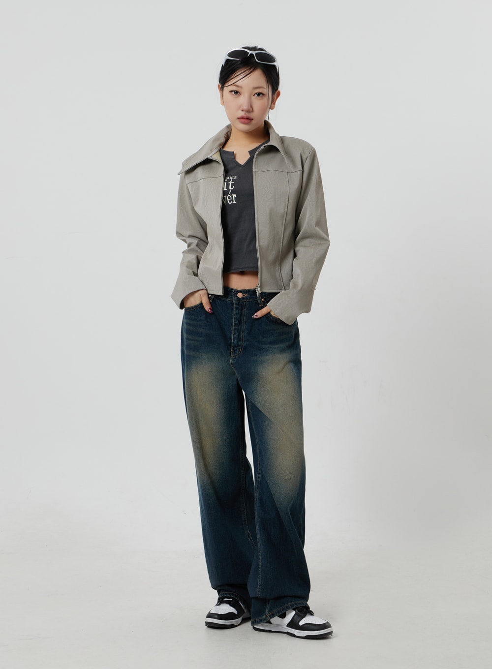 Dark Wash Jeans CF303 in blue, full-body front shot on model, deep indigo wide-leg washed denim with amber fade, hands in pockets, paired with beige jacket and graphic tee.