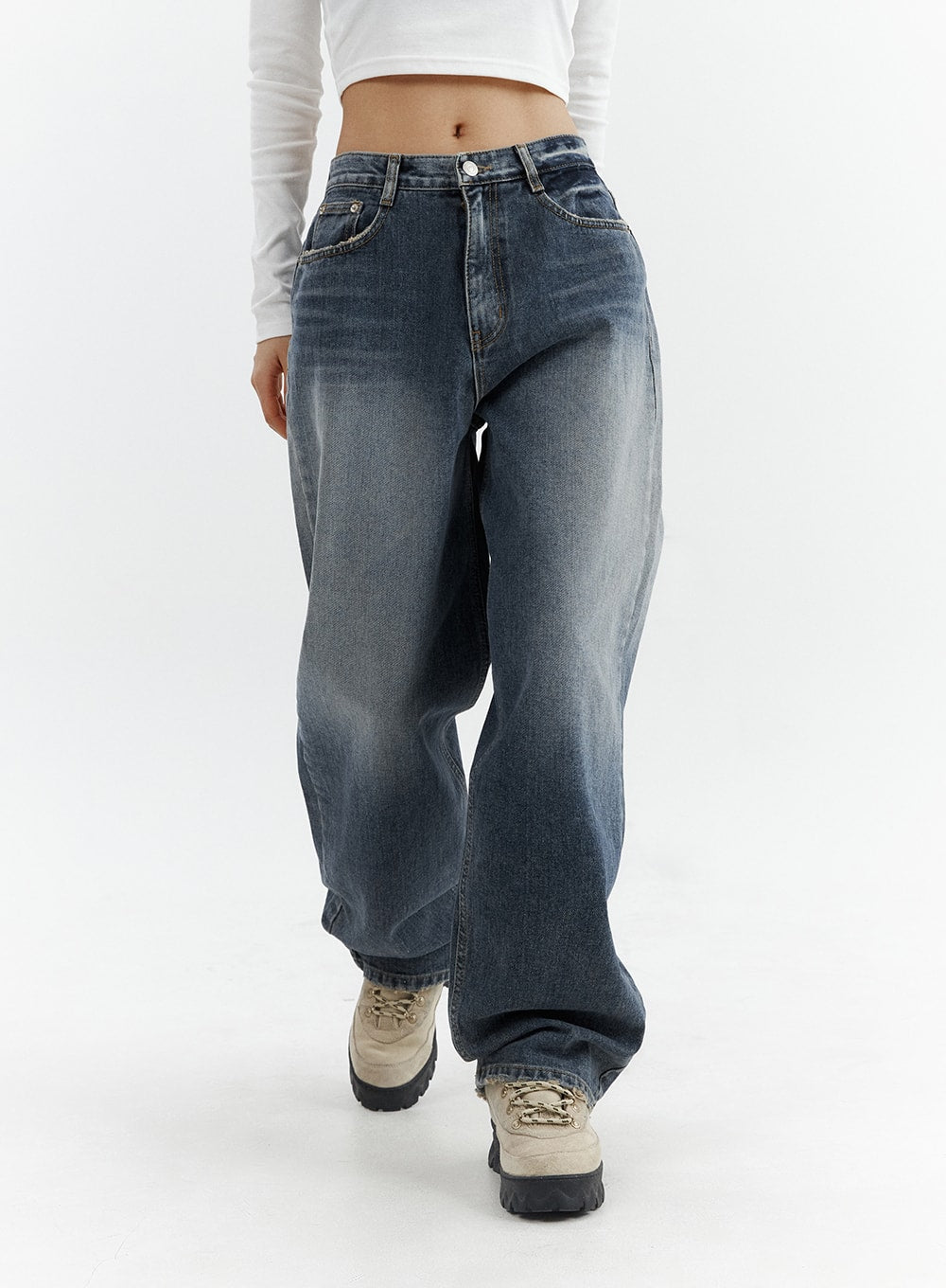 Washed Button Straight Leg Jeans CJ425 in dark blue, front mid-shot on model in walking pose, wide-fit washed denim with faded thigh highlights pooling slightly at hem over chunky sneakers.