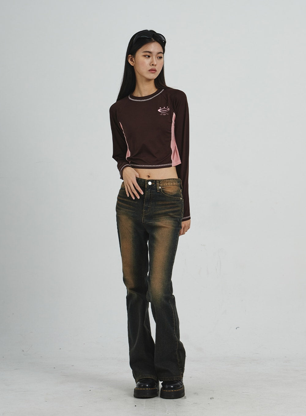 Vintage Washing Bootcut Jeans CD02 in dark washed denim, full-length slight angle front view on model, hand on hip pose highlighting slim waist, amber wash fade on thighs and bootcut flare.