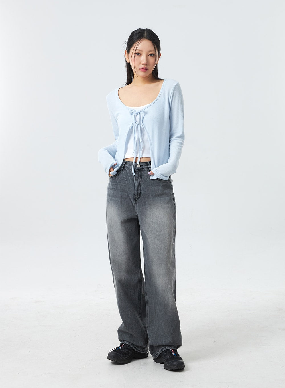 Low Rise Mid-Wash Jeans CM327 in grey, full-length front shot on model standing straight, low-rise wide-leg cotton denim with mid-wash gradient, paired with light blue crop cardigan.