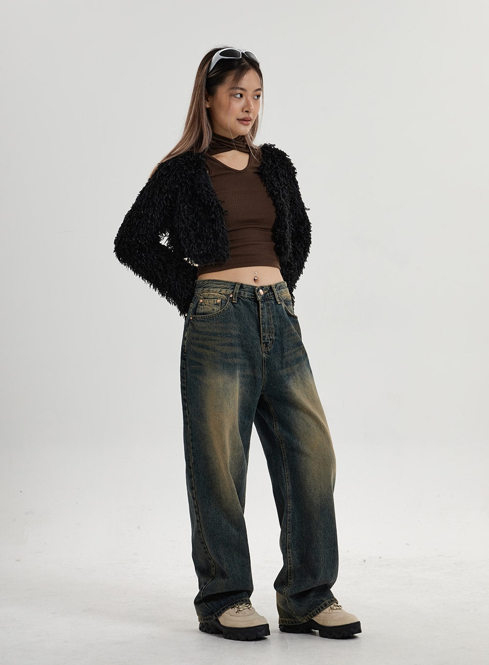 Vintage Washing Wide Leg Denim Pants CN14 in vintage washed indigo, three-quarter side view on model, wide leg cotton denim with pronounced yellow-brown wash, paired with black shaggy cardigan.