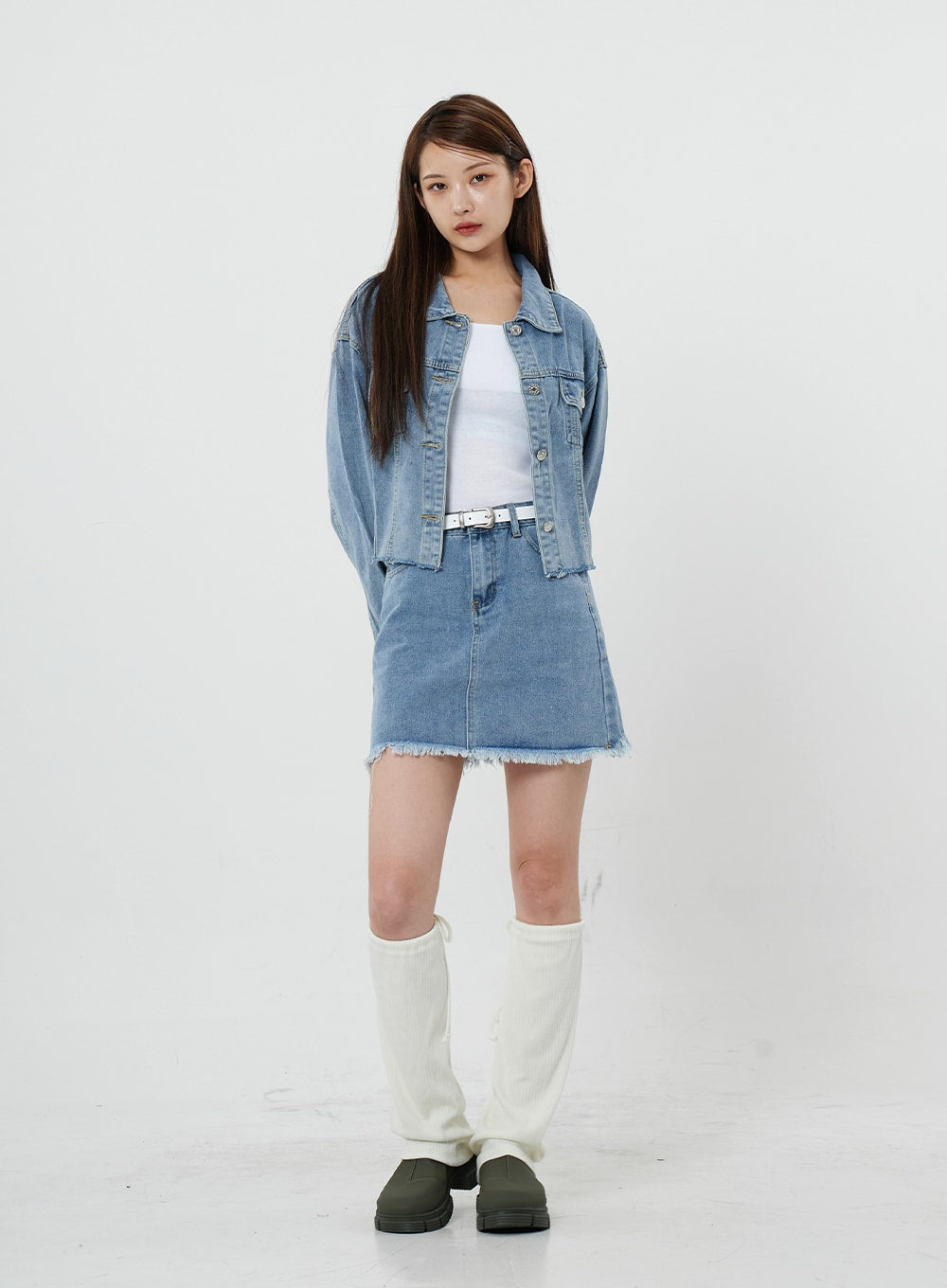 Sienna Crop Jeans Jacket CS21 in light blue, full-length front view on model, buttoned-up crop denim jacket with drop shoulders, styled with denim mini skirt and white belt.
