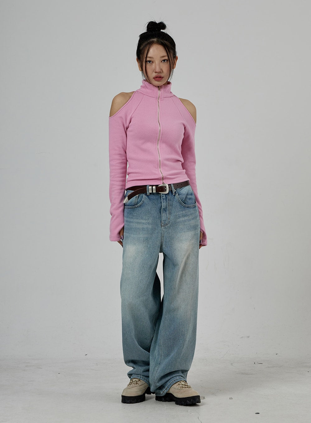 Light Wash Baggy Jeans Unisex CD26 in light blue, full-length front shot on model standing straight, oversized wide-leg washed denim, styled with pink cold-shoulder top and silver belt buckle.