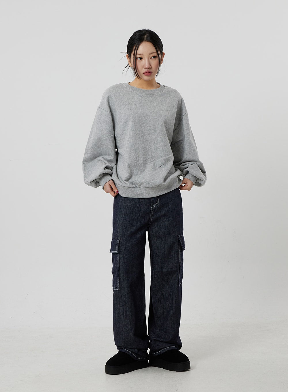 Wide Cargo Jeans CF302 in dark indigo, full-length front view on model standing straight, wide-fit cotton denim with contrast-stitch cargo pockets, paired with oversized grey sweatshirt.