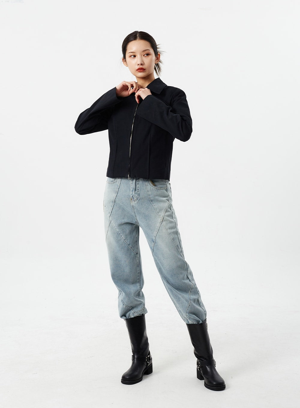 Light Wash Straight Leg Jeans CM307 in light blue, full-body slight angle on model, straight-fit washed denim with diamond seam lines, paired with black zip jacket and black knee-high boots.