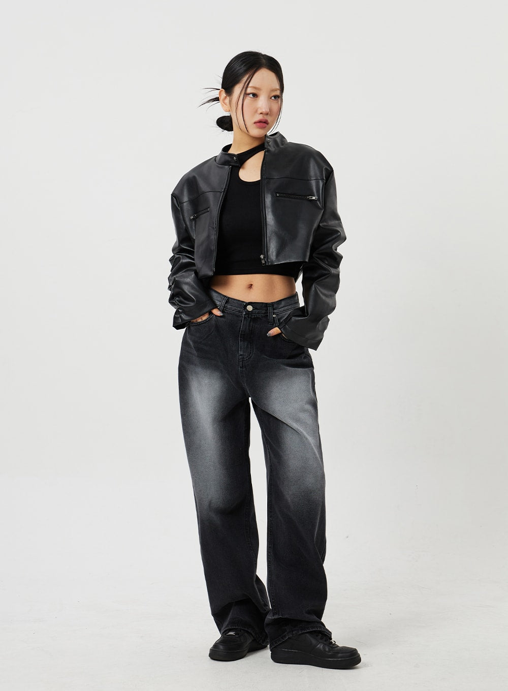 Mid-Rise Baggy Jeans CF328 in black, front full-length shot on model, wide-fit faded denim with mid-rise waist, hands in pockets, styled with cropped leather jacket and black crop top.