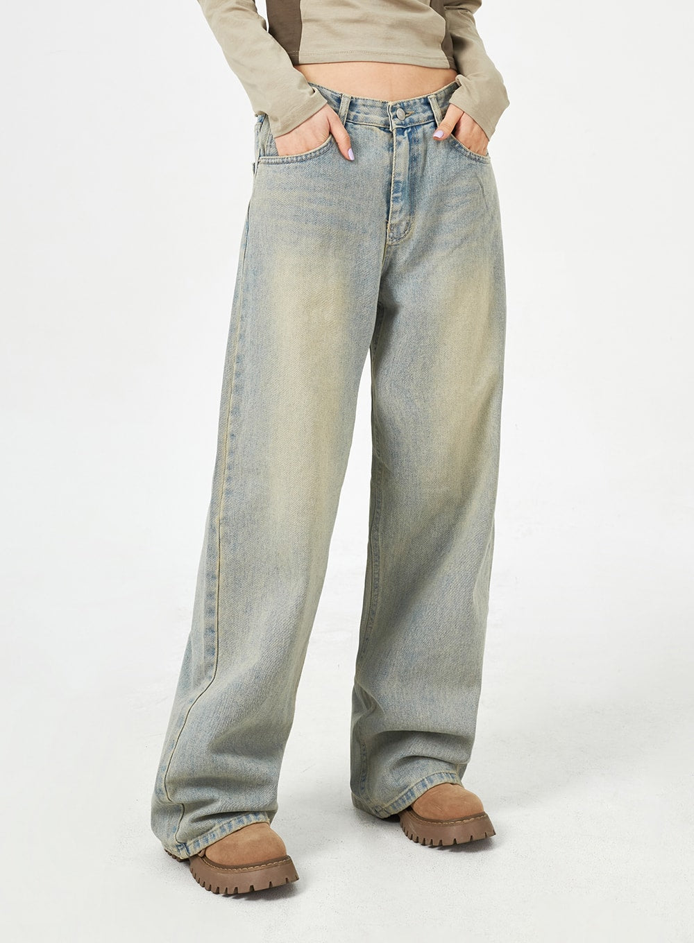 Light Blue Baggy Jeans CM323 in light blue, front close-up from waist to ankle on model, hands in pockets, wide-leg cotton denim with sun-faded wash and center seam detail.