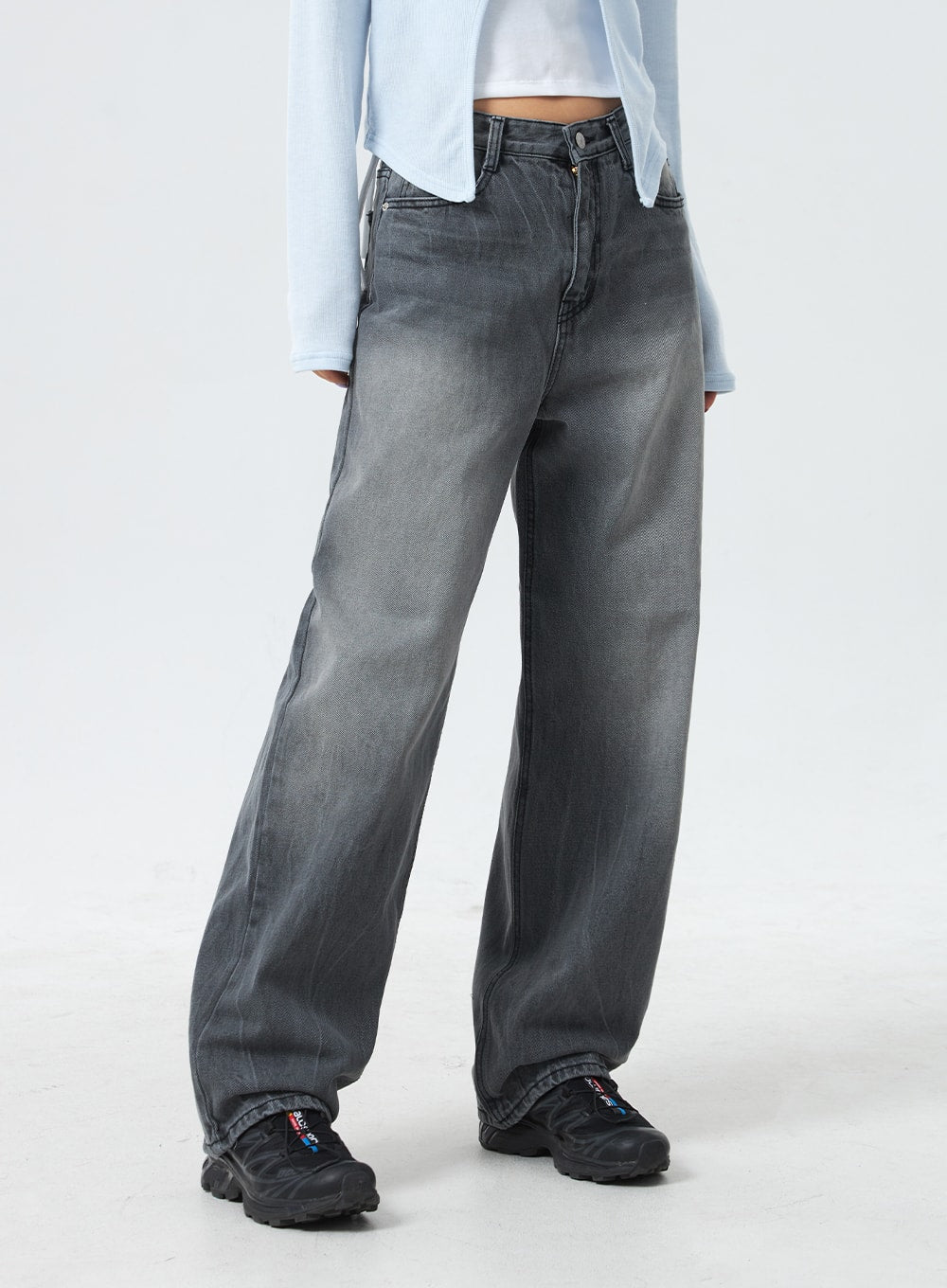 Low Rise Mid-Wash Jeans CM327 in grey, front waist-to-hem close-up on model, low-rise waistband with button detail, wide-leg cotton denim in faded grey mid-wash, pooling slightly at sneakers.