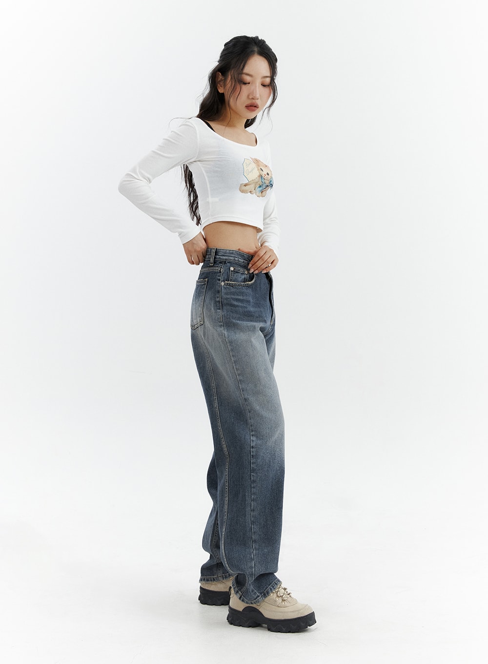 Washed Button Straight Leg Jeans CJ425 in dark blue, side view on model looking down, wide-fit washed denim showing straight side seam and full leg length, paired with white crop top and chunky sneakers.