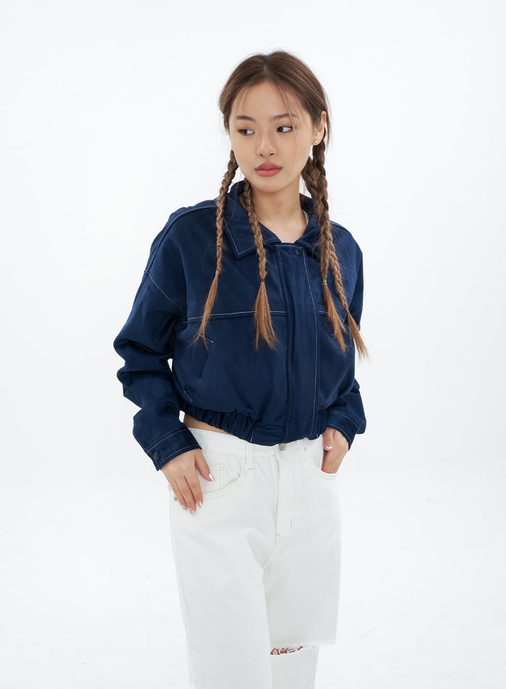 Torn Wide Leg Jeans CM18 in white, upper-hip detail shot on model, waistband and front pockets with contrast stitching visible, knee cut-out partially shown, layered under navy jacket.
