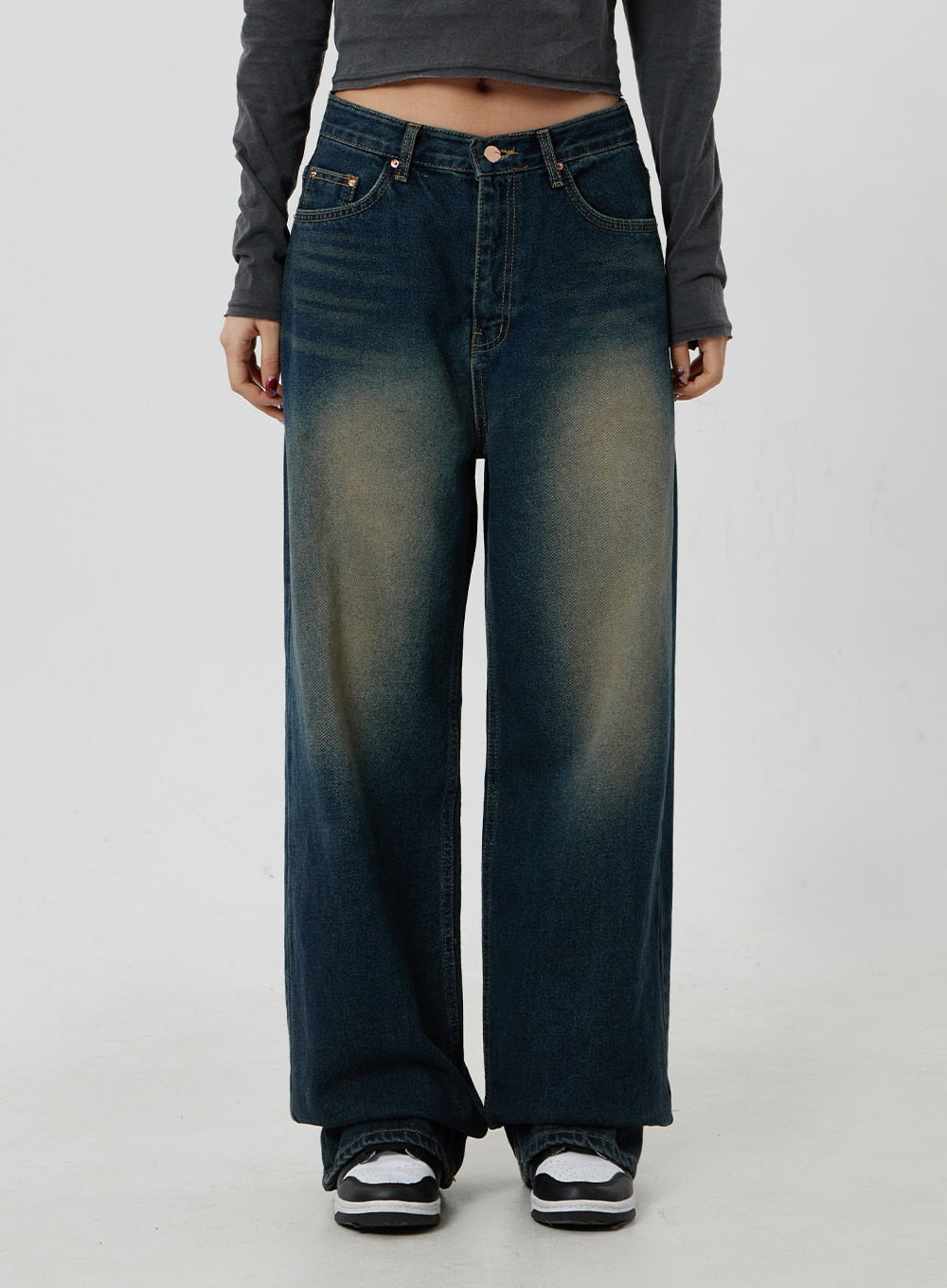 Dark Wash Jeans CF303 in blue, front close-up crop on model, deep indigo wide-leg cotton denim with bold golden-yellow washed fade at thighs and five-pocket detailing.
