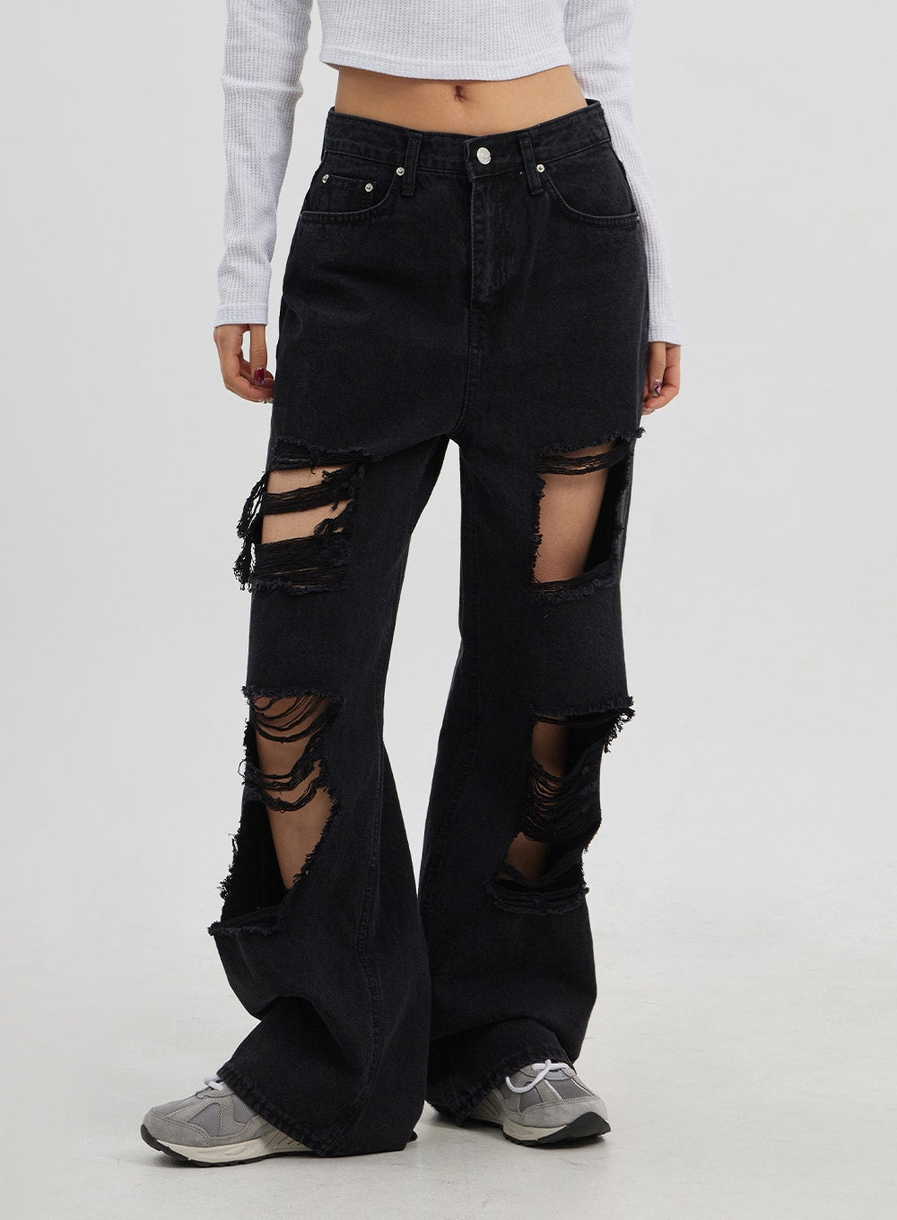Ripped Wide Leg Jeans CJ319 in black, front lower-body close-up on model, oversized wide leg with heavy frayed rip detail at thigh and calf, floor-grazing hem in cotton denim.