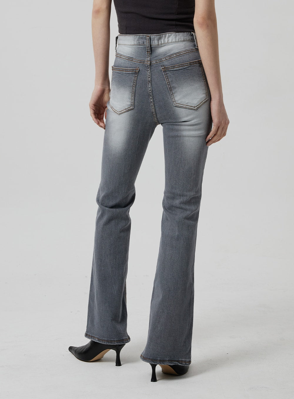 Slim Fit Bootcut Jeans CF307 in grey, back view waist-to-hem on model, dual back pockets with contrast stitching, slim seat tapering to bootcut flare, kitten heel mules.