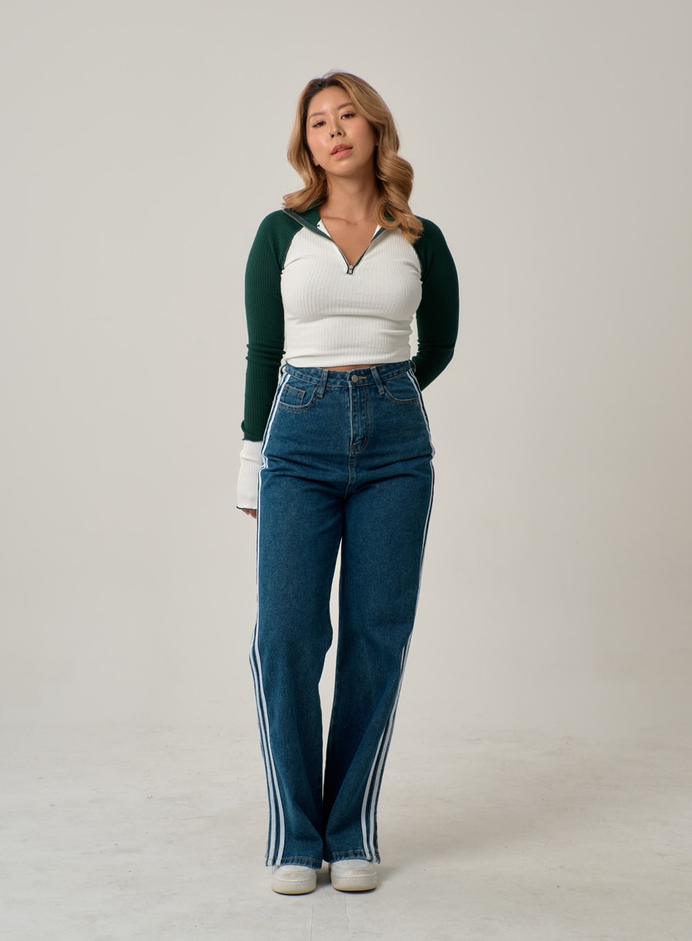 Side Stripes Straight Leg Jeans IN22 in mid blue, full-body front shot on model standing straight, wide-fit high-rise denim with white triple side stripes to hem, paired with ribbed colorblock top.