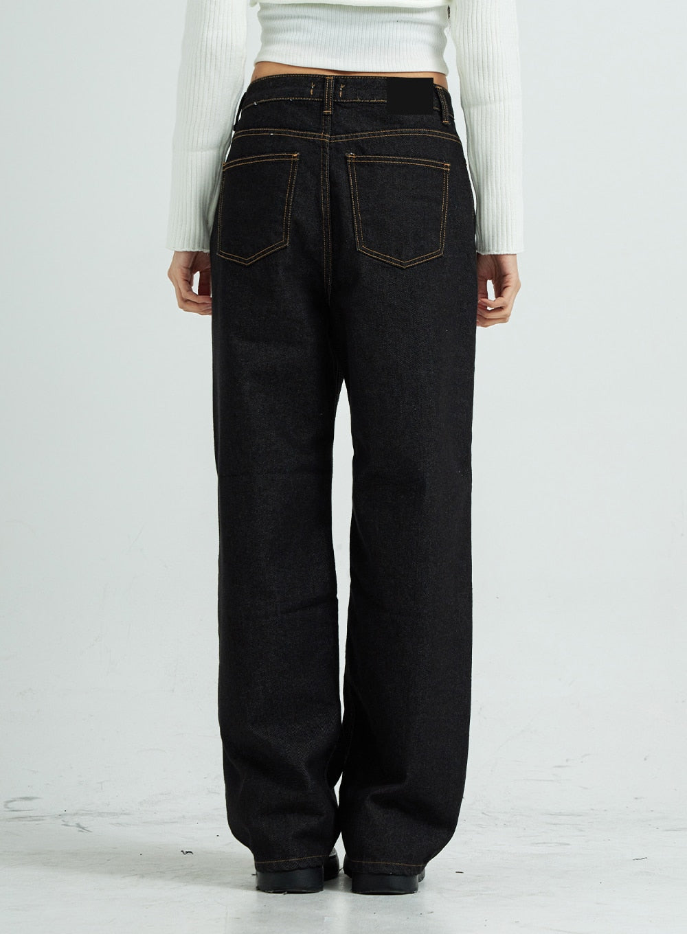 Pepe Wide Pants CS15 in black, back view close-up on model, wide-fit cotton denim showing dual back pockets with contrast topstitching and relaxed straight leg silhouette.