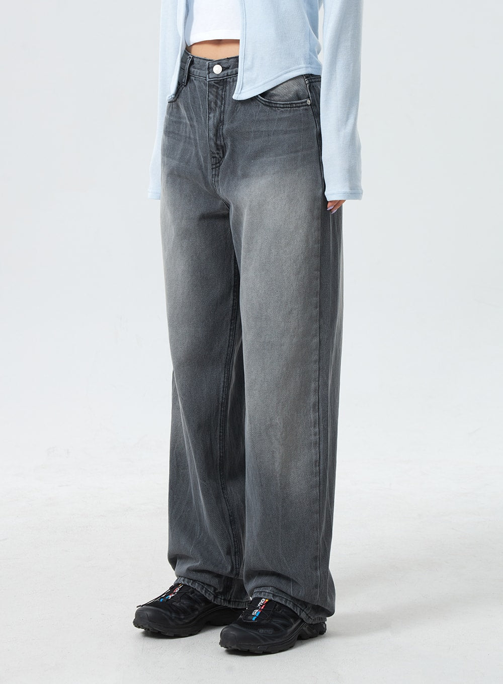 Low Rise Mid-Wash Jeans CM327 in grey, side-angled waist-to-ankle close-up on model, wide-fit denim with visible mid-wash fading and crease lines, low-rise waistband, full-length leg.