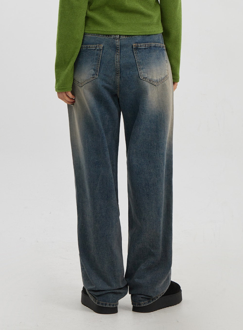 Mid-Rise Baggy Jeans Unisex CJ330 in vintage blue, back view from waist to hem on model, showing dual back pockets with stitching and all-over faded wash on wide-fit denim.